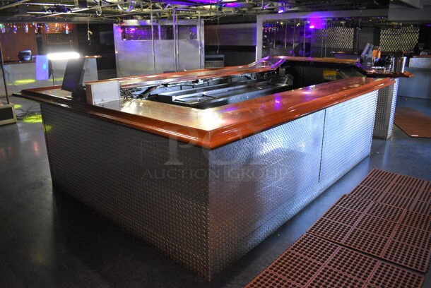 Bar w/ Brazilian Cherry Wood Bar Top and Diamond Plate Panels. BUYER MUST REMOVE. 115x300x45. (upstairs)