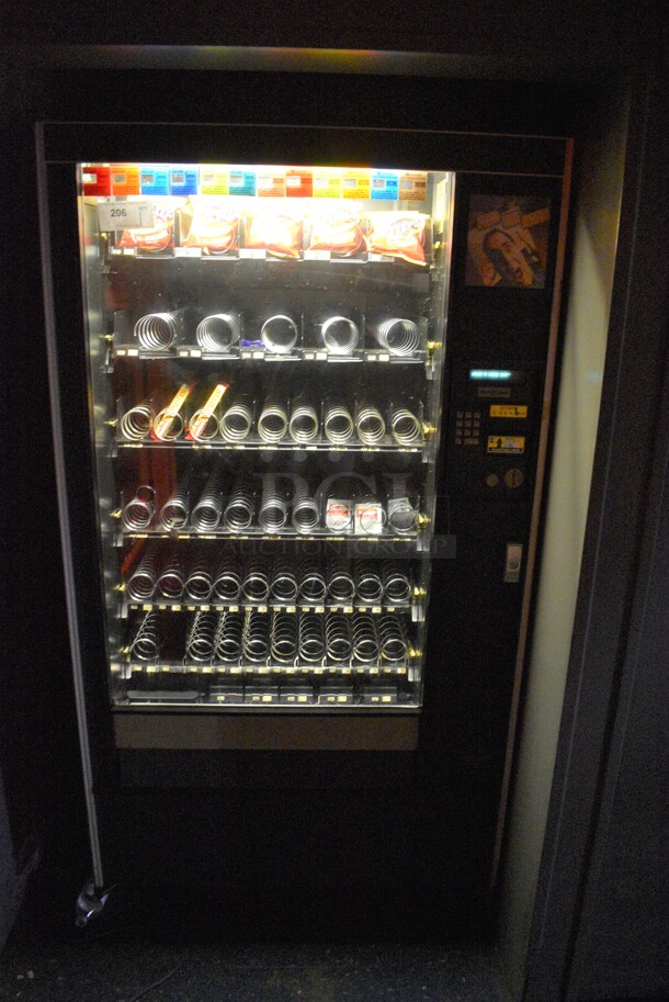 Metal Commercial Snack Vending Machine w/ Cash Acceptor on Commercial Casters. BUYER MUST REMOVE. 38x36x72. Tested and Working! (upstairs)