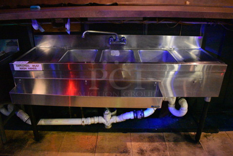 Stainless Steel Commercial 3 Bay Back Bar Sink w/ Dual Drain Boards, Faucet, Handles and Speedwell. BUYER MUST REMOVE. 59x24x34. Bays 10x14x10. Drain Boards 12x16x1. (upstairs)