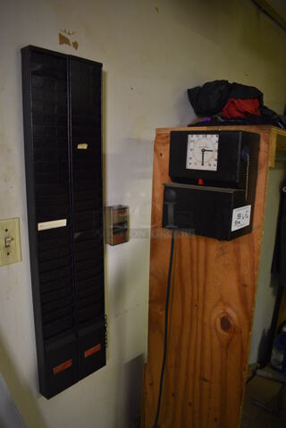 Lathem Metal Commercial Time Clock and 2 Metal Time Card Holders. BUYER MUST REMOVE. 7.5x5.5x10, 4.5x1x37. (dishwasher area)
