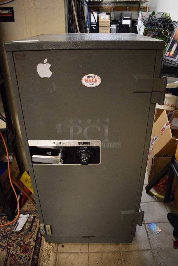 Diebold 1643 Gray Metal Single Compartment Safe. Does Not Include Contents. Combination Will Be Given to Winning Bidder On Pick Up Day. BUYER MUST REMOVE. 23x27x49. (office)