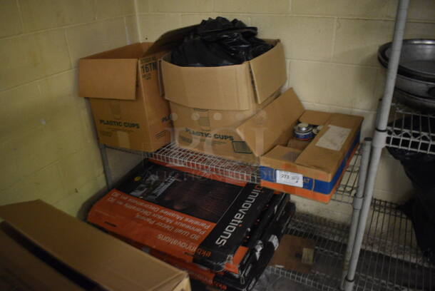 ALL ONE MONEY! Lot of Metal 2 Tier Shelving Unit w/ Contents Including Chafing Dish Fuel and Poly Pitchers. BUYER MUST DISMANTLE. PCI CANNOT DISMANTLE FOR SHIPPING. PLEASE CONSIDER FREIGHT CHARGES. 54x18x35. BUYER MUST REMOVE. (basement) - Image 1 of 5