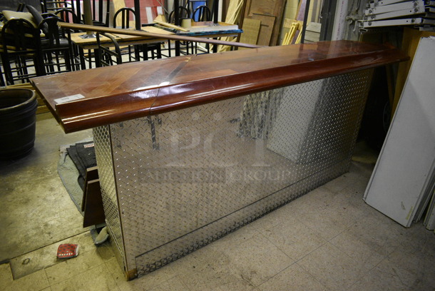 Bar w/ Brazilian Cherry Wood Bar Top and Diamond Plate Panels. BUYER MUST REMOVE. 100x26x43. (basement)