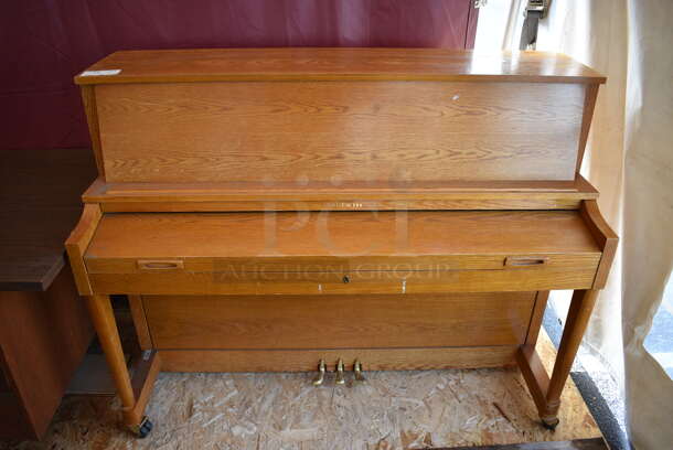 Baldwin Wooden Piano on Casters. 57x25x44.5