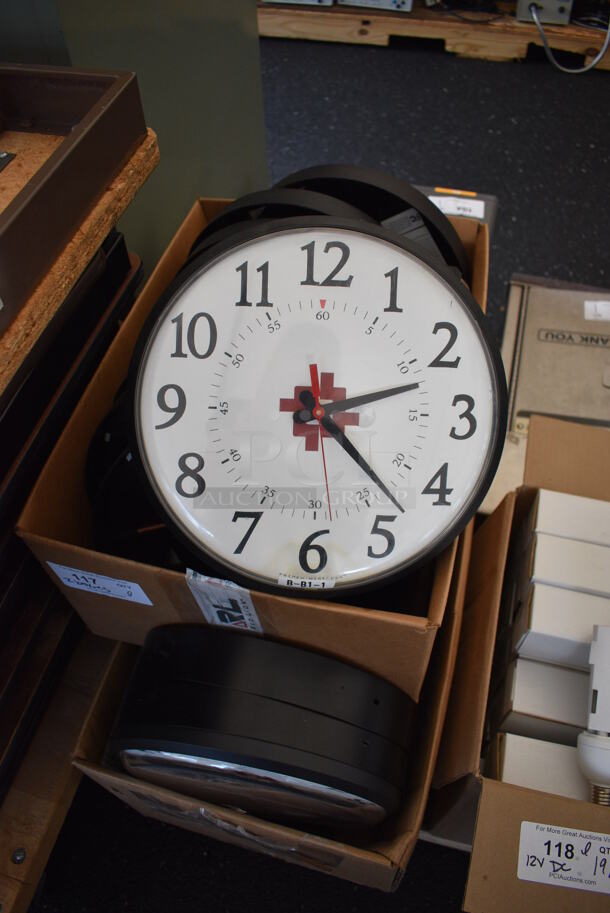 ALL ONE MONEY! Lot of 2 Boxes of PrimeX Clocks w/ HACC Logo. These clocks have the ability to be hooked up to an atomic clock in Colorado if you pay for a subscription, get a receiver and GPS antenna. If you don't do that, you can press the red button and that changes the clock to being battery powered. Approximately 20 Clocks. 12.5x2.5x12.5