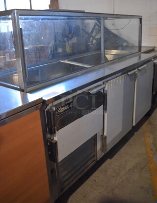 2017 Leader LM72 S/C Stainless Steel Commercial 3 Door Cooler w/ Attached Glass Top on Commercial Casters. 115 Volts, 1 Phase. 72x32x56. Tested and Working!