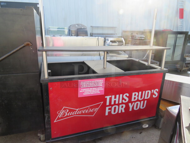 One Budweiser Ice Down Merchandiser With Over Shelf, Under Shelf, Drain On Casters. 62X30X48
