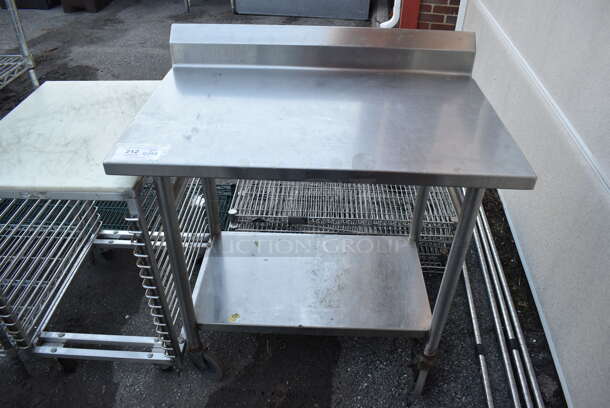 Stainless Steel Table w/ Back Splash and Under Shelf on Commercial Casters. 36x24x39