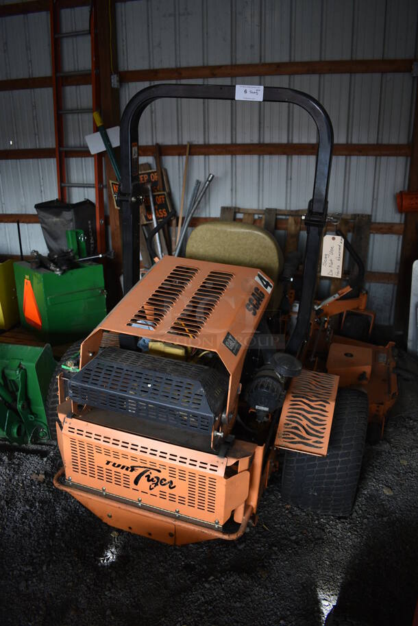 Scag STT-28CAT-SS Metal Commercial Turf Tiger Riding Lawn Mower. Unit Has Had Some Parts Removed. BUYER MUST REMOVE. 84x95x67. (HS: Garage 1)