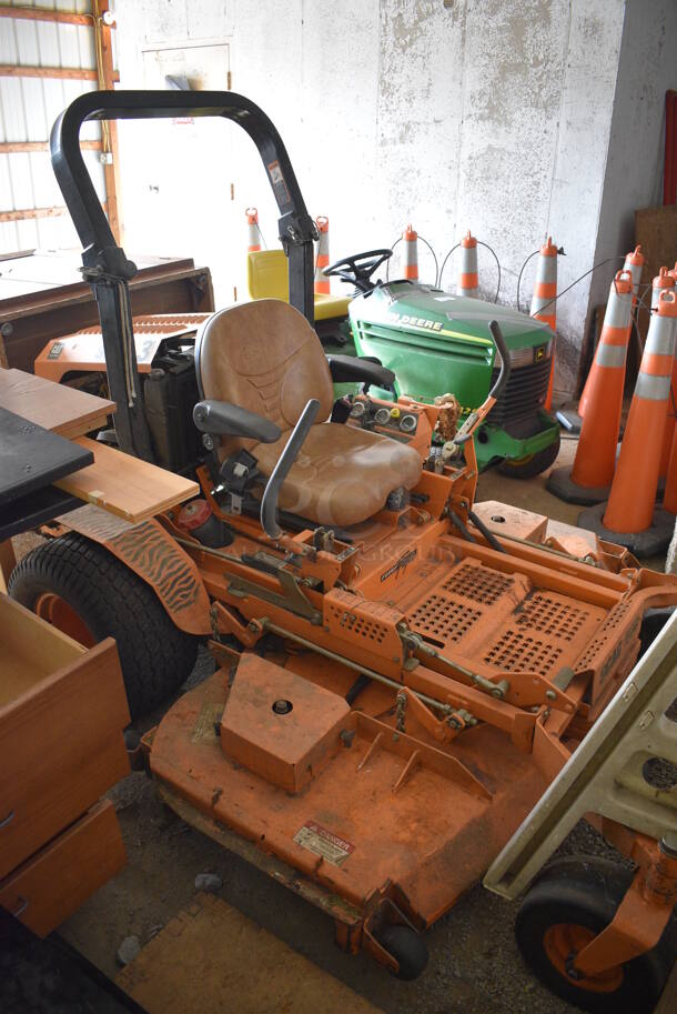 Scag STT-28CAT-SS Metal Commercial Turf Tiger Riding Lawn Mower. Hours Read 1549. BUYER MUST REMOVE. 72x95x68. Unit Is Hard To Start and Shuts Off While Mowing. (HS: Garage 2)