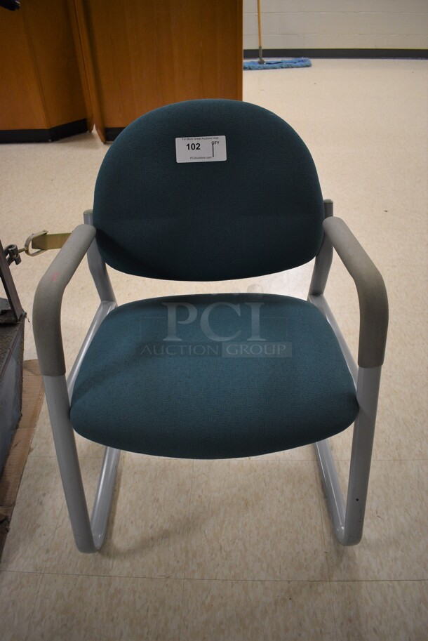 Gray Metal Chair w/ Blue Cushions. 24x24x31. (MS: Downstairs 005)