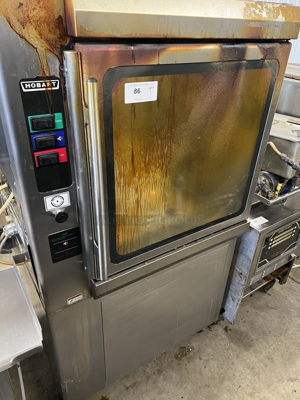 Hobart KA7E Stainless Steel Commercial Floor Style Electric Powered Self Cleaning Rotisserie Oven on Commercial Casters. 208 Volts, 3/1 Phase. 38x35x71