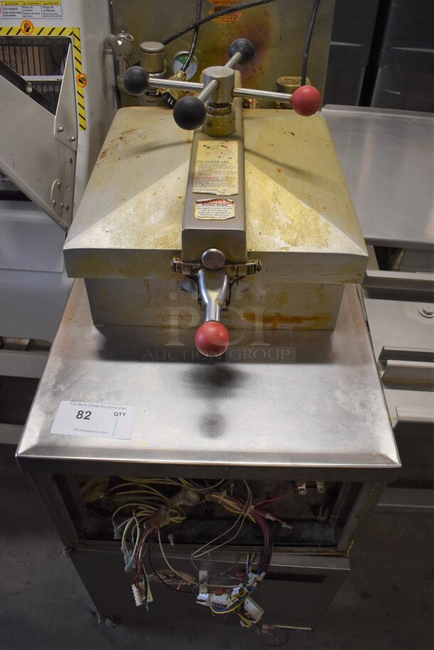 Henny Penny 600 Stainless Steel Commercial Floor Style Natural Gas Powered Pressure Fryer on Commercial Casters. Missing Front Panel. 80,000 BTU. 18x39x49