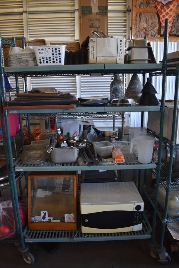 ALL ONE MONEY! Metro Lot of Various Items Including Framed Pictures, Utensils, Display Case, General Electric Microwave Oven. Does Not Include Shelving Unit