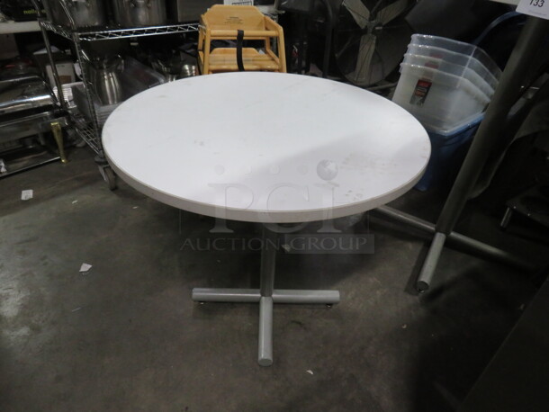 One White Laminate Table Top On A  Pedestal Base. 30X30X29.5