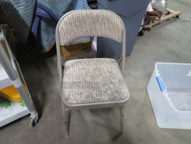 One Folding Chair With Cushioned seat And Back.