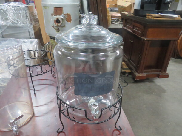 One Glass Beverage Dispenser With Spigot Lid And Metal Stand.