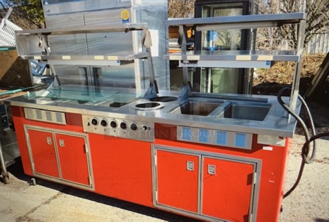 One AWESOME WORKING Delfield 5 Well Steam Table With 4 SS Over Shelves With Hatco Warmers, 4 Doors Under With Storage, And Sneeze Guards On Casters. Model# KH-6-NU. 240 Volt. 96X38X60.