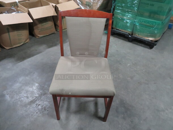 One Wooden Chair With With Beige Cushioned Seat And Back.