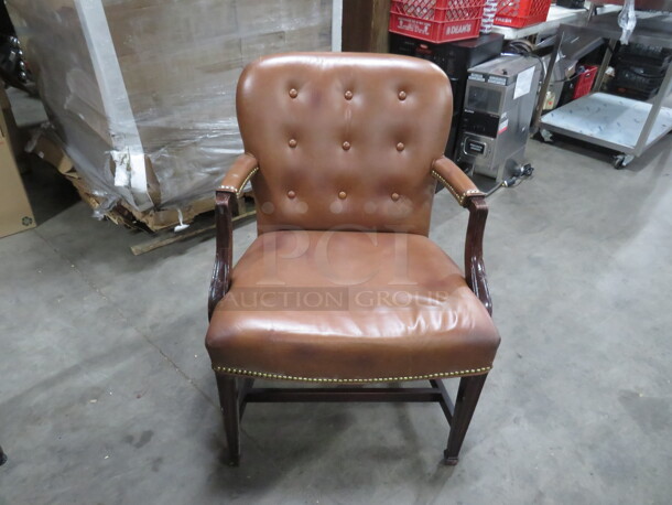 Wooden Arm Chair With Brown Leather  Cushioned Seat And Back, And Nail Head Trim. 2XBID