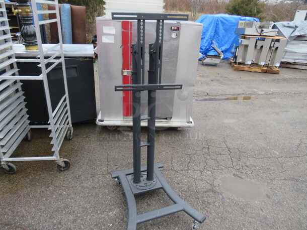 One Metal TV Cart. On Casters 24X30X57
