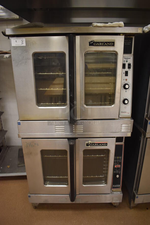 2 Garland Master 200 Stainless Steel Commercial Natural Gas Powered Full Size Convection Ovens w/ View Through Doors, Metal Oven Racks and Thermostatic Controls. BUYER MUST REMOVE. 38x42x71.5. 2 Times Your Bid! Tested and Working! (Pastry Kitchen)