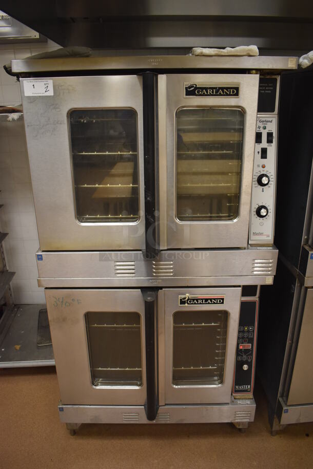 2 Garland Master 200 Stainless Steel Commercial Natural Gas Powered Full Size Convection Ovens w/ View Through Doors, Metal Oven Racks and Thermostatic Controls. BUYER MUST REMOVE. 38x42x71.5. 2 Times Your Bid! Tested and Working! (Pastry Kitchen) - Image 1 of 9