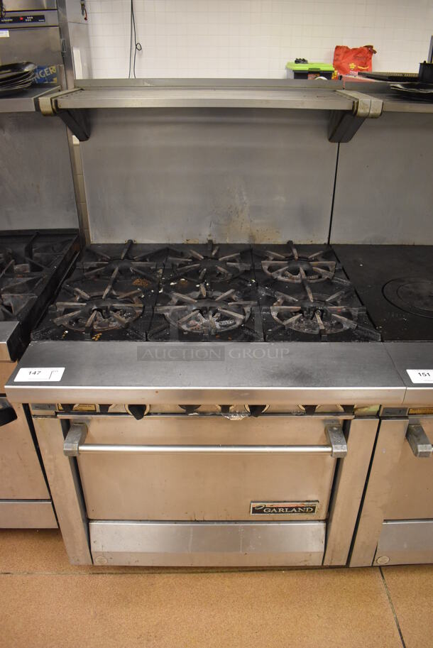 Garland M43R Stainless Steel Commercial Floor Style Natural Gas Powered 2 Burner Range w/ Flat Top, Oven, Over Shelf and Back Splash. BUYER MUST REMOVE. 34x38x58. Tested and Working! (Restaurant Kitchen)