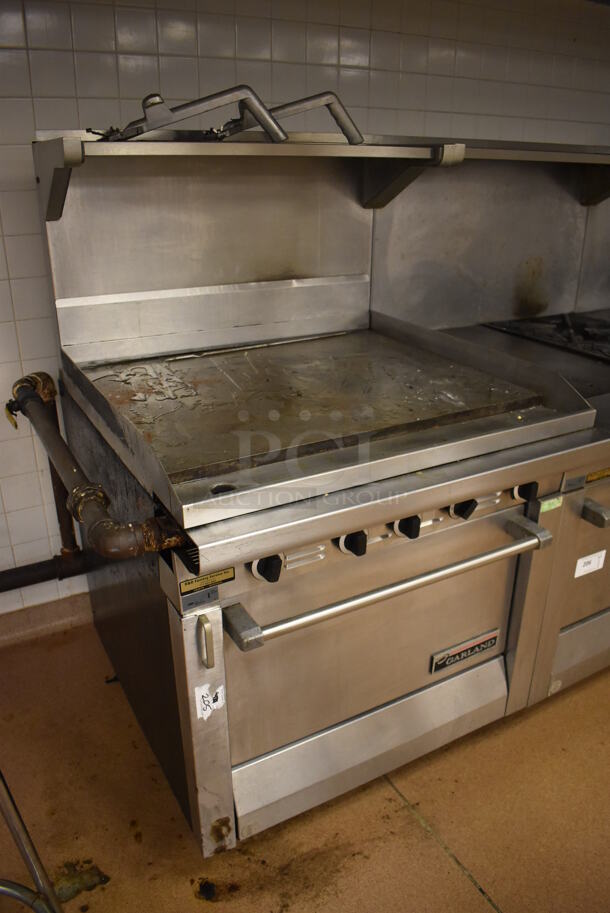 Garland M47R Stainless Steel Commercial Floor Style Natural Gas Powered Flat Top w/ Oven, Over Shelf and Back Splash. BUYER MUST REMOVE. 34x38x58. (Education Kitchen 2) - Image 2 of 7