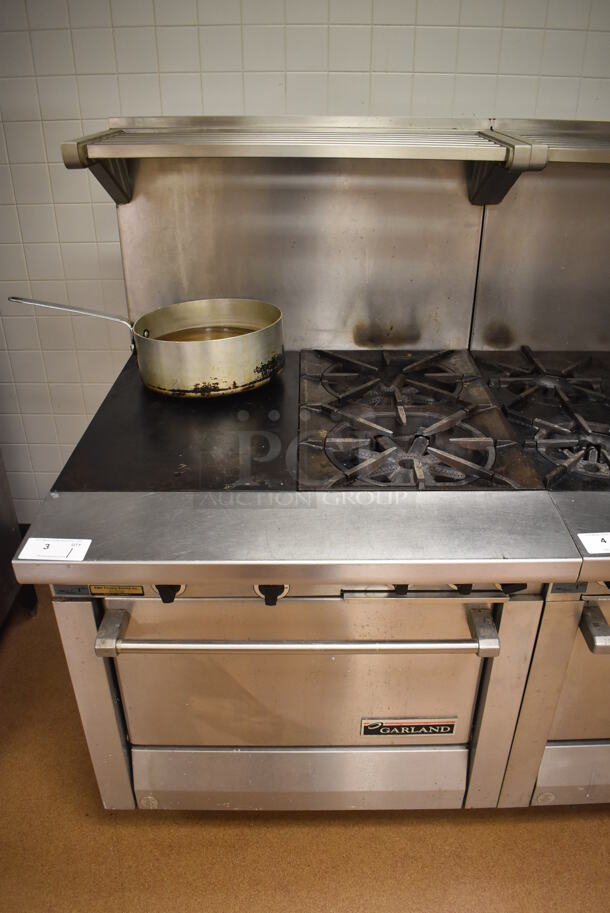 Garland M42-6R Stainless Steel Commercial Floor Style Natural Gas Powered 2 Burner Range w/ Flat Top, Oven, Over Shelf and Back Splash. BUYER MUST REMOVE. 34x38x58. Tested and Working! (Pastry Kitchen) - Image 1 of 8