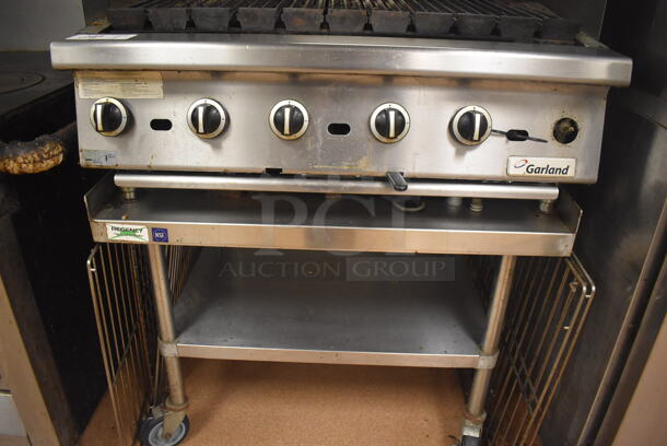 LATE MODEL! Garland Stainless Steel Commercial Countertop Gas Powered Charbroiler Grill w/ Side Splash Guards on Regency Stainless Steel Equipment Stand on Commercial Casters. BUYER MUST REMOVE. 35.5x32x26, 36x30x30. Tested and Working! (Restaurant Kitchen) - Image 4 of 6