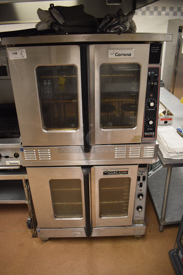 2 Garland Master 200 Stainless Steel Commercial Natural Gas Powered Full Size Convection Ovens w/ View Through Doors, Metal Oven Racks and Thermostatic Controls. BUYER MUST REMOVE. 38x42x71. 2 Times Your Bid! Tested and Working! (Restaurant Kitchen)