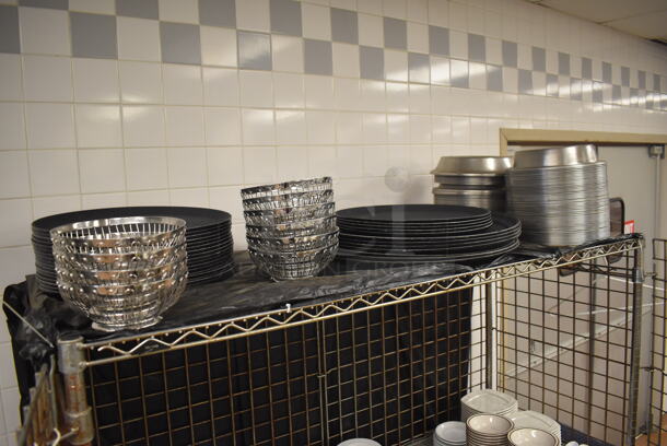 Chrome Finish 3 Tier Wire Shelving Unit w/ Liquor Cage on Commercial Casters. Comes w/ Contents Including Plates, Serving Trays and Metal Baskets. BUYER MUST DISMANTLE. PCI CANNOT DISMANTLE FOR SHIPPING. PLEASE CONSIDER FREIGHT CHARGES. 62x27x68. (Restaurant Kitchen) - Image 2 of 6