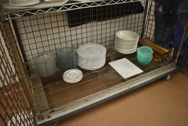 Chrome Finish 3 Tier Wire Shelving Unit w/ Liquor Cage on Commercial Casters. Comes w/ Contents Including Plates, Serving Trays and Metal Baskets. BUYER MUST DISMANTLE. PCI CANNOT DISMANTLE FOR SHIPPING. PLEASE CONSIDER FREIGHT CHARGES. 62x27x68. (Restaurant Kitchen) - Image 4 of 6
