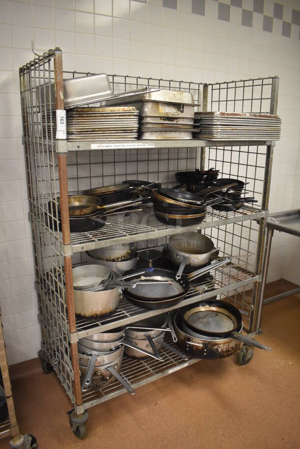 Metal 4 Tier Wire Shelving Unit w/ Contents Including Metal Baking Pans, Drop In Bins and Skillets on Commercial Casters. BUYER MUST DISMANTLE. PCI CANNOT DISMANTLE FOR SHIPPING. PLEASE CONSIDER FREIGHT CHARGES. 48x24x70. (Restaurant Kitchen) - Image 1 of 11