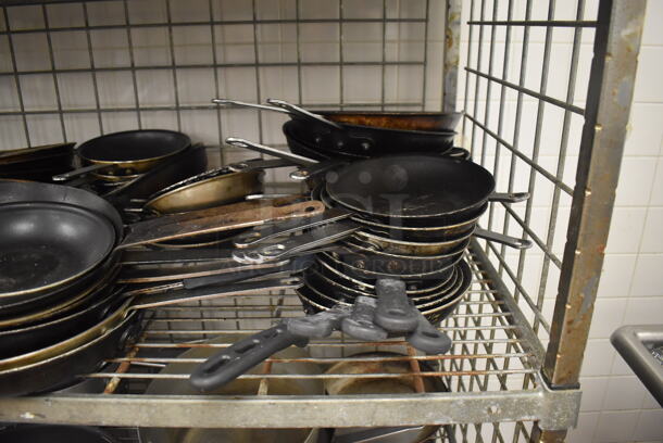 Metal 4 Tier Wire Shelving Unit w/ Contents Including Metal Baking Pans, Drop In Bins and Skillets on Commercial Casters. BUYER MUST DISMANTLE. PCI CANNOT DISMANTLE FOR SHIPPING. PLEASE CONSIDER FREIGHT CHARGES. 48x24x70. (Restaurant Kitchen) - Image 5 of 11