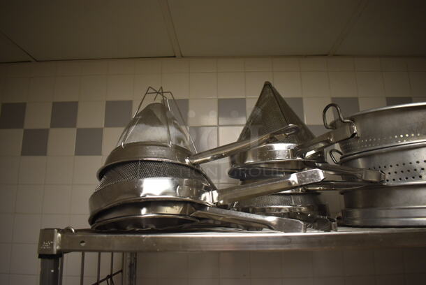 Metal 4 Tier Wire Shelving Unit on Commercial Casters w/ Contents Including Metal Bowls, Skillets and China Cap Strainers. BUYER MUST DISMANTLE. PCI CANNOT DISMANTLE FOR SHIPPING. PLEASE CONSIDER FREIGHT CHARGES. 60x24x78. (Education Kitchen 2) - Image 3 of 11