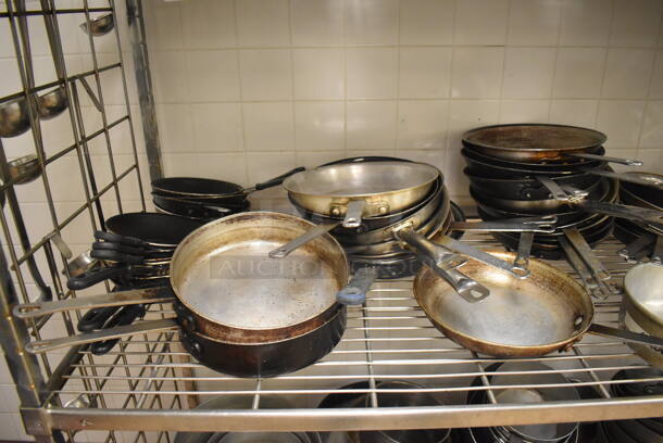 Metal 4 Tier Wire Shelving Unit on Commercial Casters w/ Contents Including Metal Bowls, Skillets and China Cap Strainers. BUYER MUST DISMANTLE. PCI CANNOT DISMANTLE FOR SHIPPING. PLEASE CONSIDER FREIGHT CHARGES. 60x24x78. (Education Kitchen 2) - Image 7 of 11