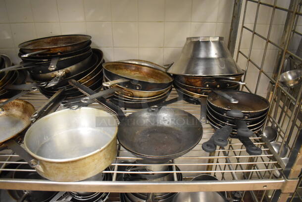 Metal 4 Tier Wire Shelving Unit on Commercial Casters w/ Contents Including Metal Bowls, Skillets and China Cap Strainers. BUYER MUST DISMANTLE. PCI CANNOT DISMANTLE FOR SHIPPING. PLEASE CONSIDER FREIGHT CHARGES. 60x24x78. (Education Kitchen 2) - Image 8 of 11