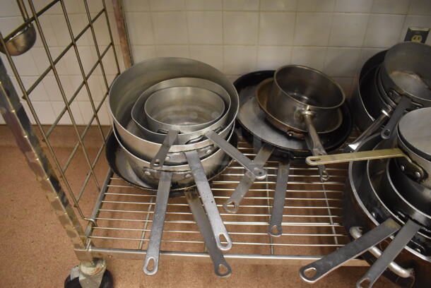 Metal 4 Tier Wire Shelving Unit on Commercial Casters w/ Contents Including Metal Bowls, Skillets and China Cap Strainers. BUYER MUST DISMANTLE. PCI CANNOT DISMANTLE FOR SHIPPING. PLEASE CONSIDER FREIGHT CHARGES. 60x24x78. (Education Kitchen 2) - Image 10 of 11