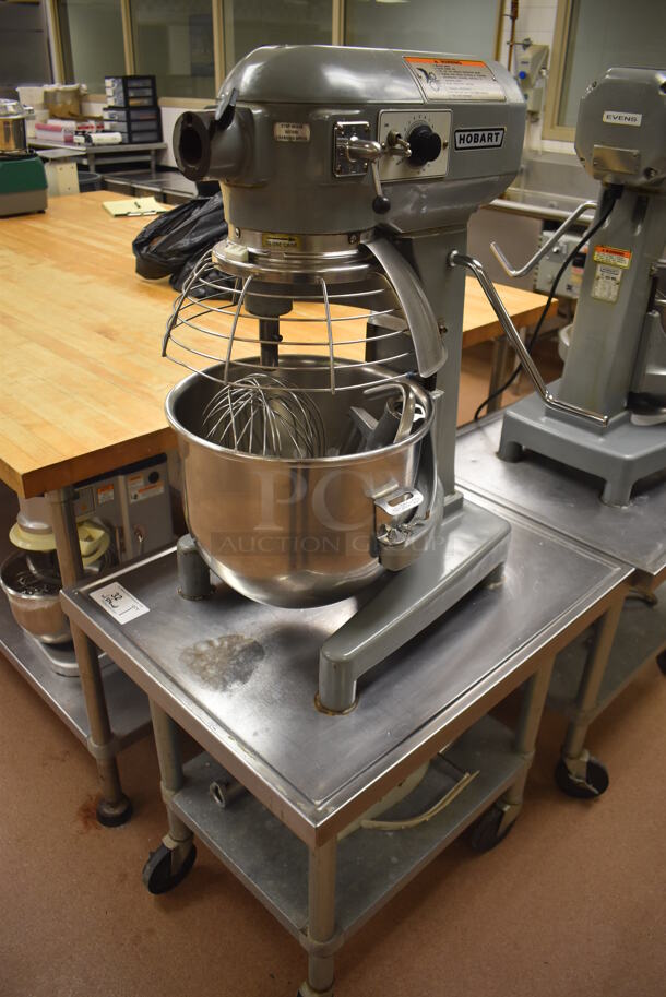 Hobart A200 Metal Commercial Countertop 20 Quart Planetary Dough Mixer w/ Stainless Steel Mixing Bowl, Bowl Guard, Whisk, 2 Paddle, 2 Dough Hook and 2 Pastry Hook Attachments on Stainless Steel Commercial Equipment Stand w/ Under Shelf. 115 Volts, 1 Phase. 17x20x31, 24x30x29. Tested and Working! (Pastry Kitchen)