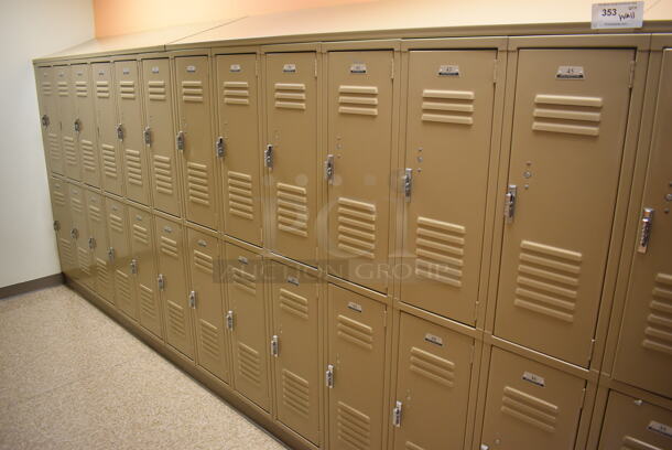 Wall of 46 Tan Metal Lockers. BUYER MUST REMOVE. 280x18x71. (Womens Locker Room)