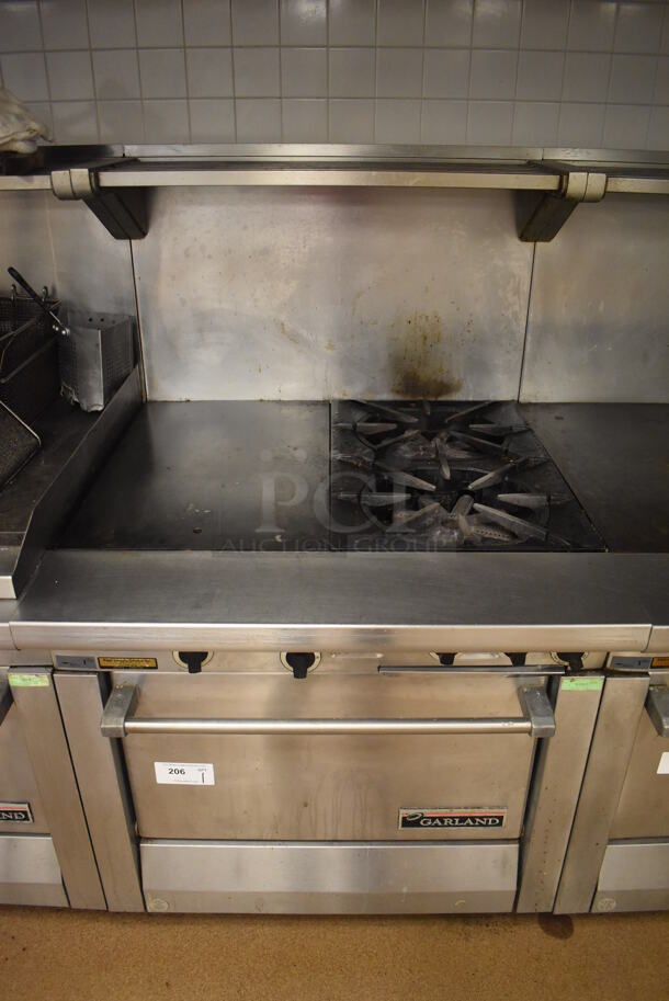 Garland M42-6R Stainless Steel Commercial Floor Style Natural Gas Powered 2 Burner Range w/ Flat Top, Oven, Over Shelf and Back Splash. BUYER MUST REMOVE. 34x38x58. Tested and Working! (Education Kitchen 2) - Image 1 of 9