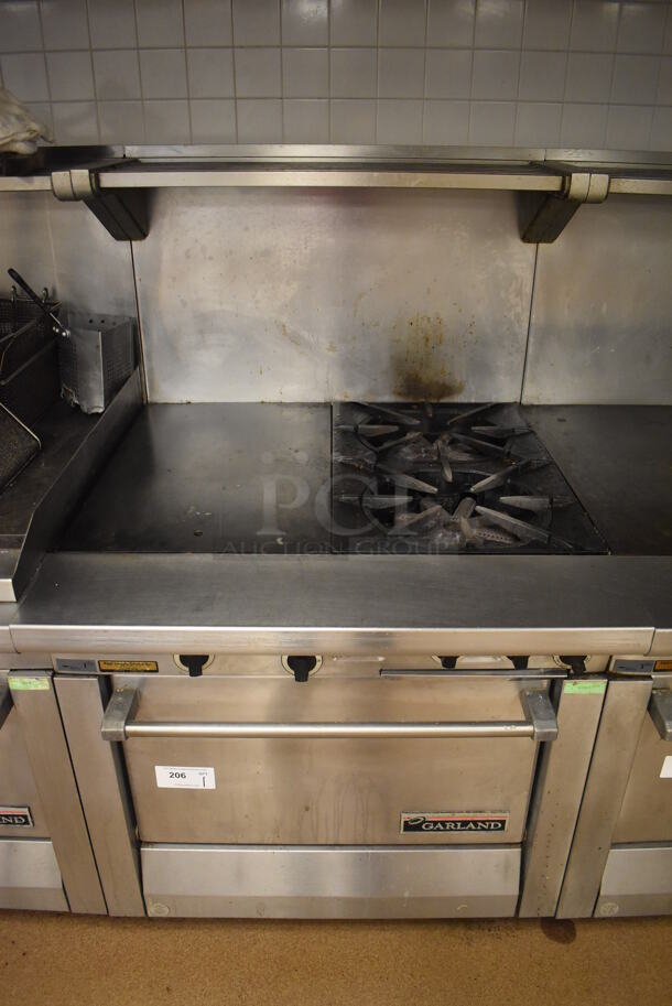 Garland M42-6R Stainless Steel Commercial Floor Style Natural Gas Powered 2 Burner Range w/ Flat Top, Oven, Over Shelf and Back Splash. BUYER MUST REMOVE. 34x38x58. Tested and Working! (Education Kitchen 2)