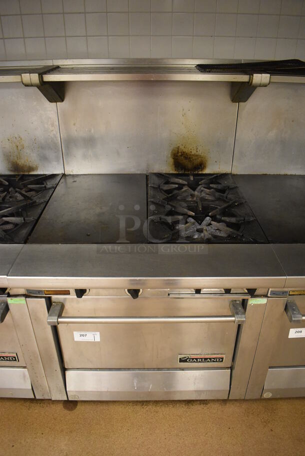 Garland M42-6R Stainless Steel Commercial Floor Style Natural Gas Powered 2 Burner Range w/ Flat Top, Oven, Over Shelf and Back Splash. BUYER MUST REMOVE. 34x38x58. Tested and Working! (Education Kitchen 2) - Image 1 of 8