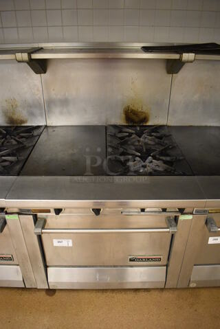 Garland M42-6R Stainless Steel Commercial Floor Style Natural Gas Powered 2 Burner Range w/ Flat Top, Oven, Over Shelf and Back Splash. BUYER MUST REMOVE. 34x38x58. Tested and Working! (Education Kitchen 2)