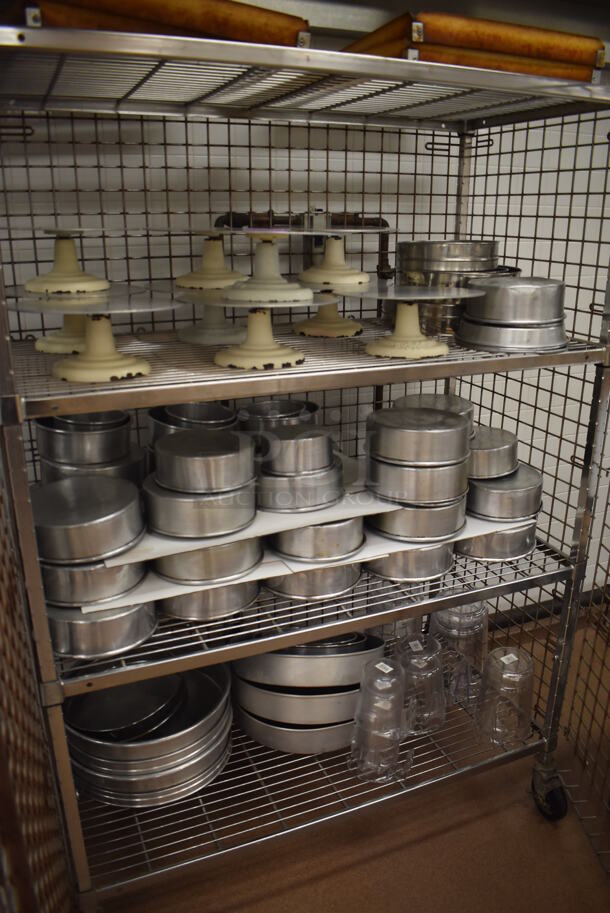 Chrome Finish 4 Tier Wire Shelving Unit w/ Liquor Cage on Commercial Casters. Comes w/ Contents Including 10 Metal Cake Stands and Various Metal Round Baking Pans. BUYER MUST DISMANTLE. PCI CANNOT DISMANTLE FOR SHIPPING. PLEASE CONSIDER FREIGHT CHARGES. 48x25x70. (Pastry Kitchen) - Image 2 of 7