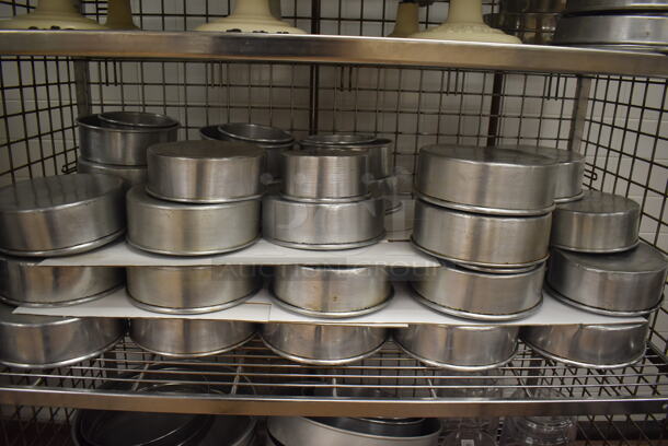 Chrome Finish 4 Tier Wire Shelving Unit w/ Liquor Cage on Commercial Casters. Comes w/ Contents Including 10 Metal Cake Stands and Various Metal Round Baking Pans. BUYER MUST DISMANTLE. PCI CANNOT DISMANTLE FOR SHIPPING. PLEASE CONSIDER FREIGHT CHARGES. 48x25x70. (Pastry Kitchen) - Image 4 of 7