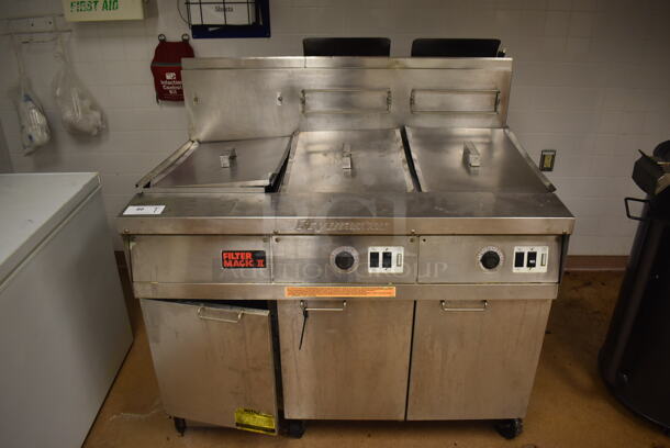 Frymaster FM245ESC Stainless Steel Commercial Floor Style Natural Gas Powered 2 Bay Deep Fat Fryer w/ Left Side Filter Magic II Filter Station and 3 Lids on Commercial Casters. 122,000 BTU. BUYER MUST REMOVE. 47x32x48. Tested and Working! (Education Kitchen)