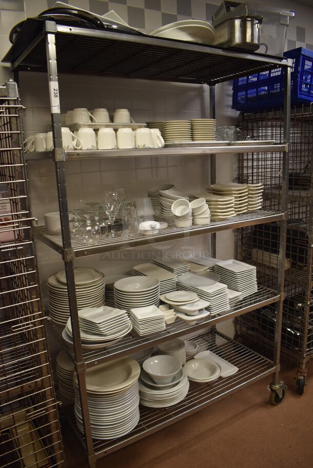 Metal 5 Tier Wire Shelving Unit on Commercial Casters w/ Contents Including Plates, Bowls and Mugs.  BUYER MUST DISMANTLE. PCI CANNOT DISMANTLE FOR SHIPPING. PLEASE CONSIDER FREIGHT CHARGES. 48x24x78. (Dishroom)